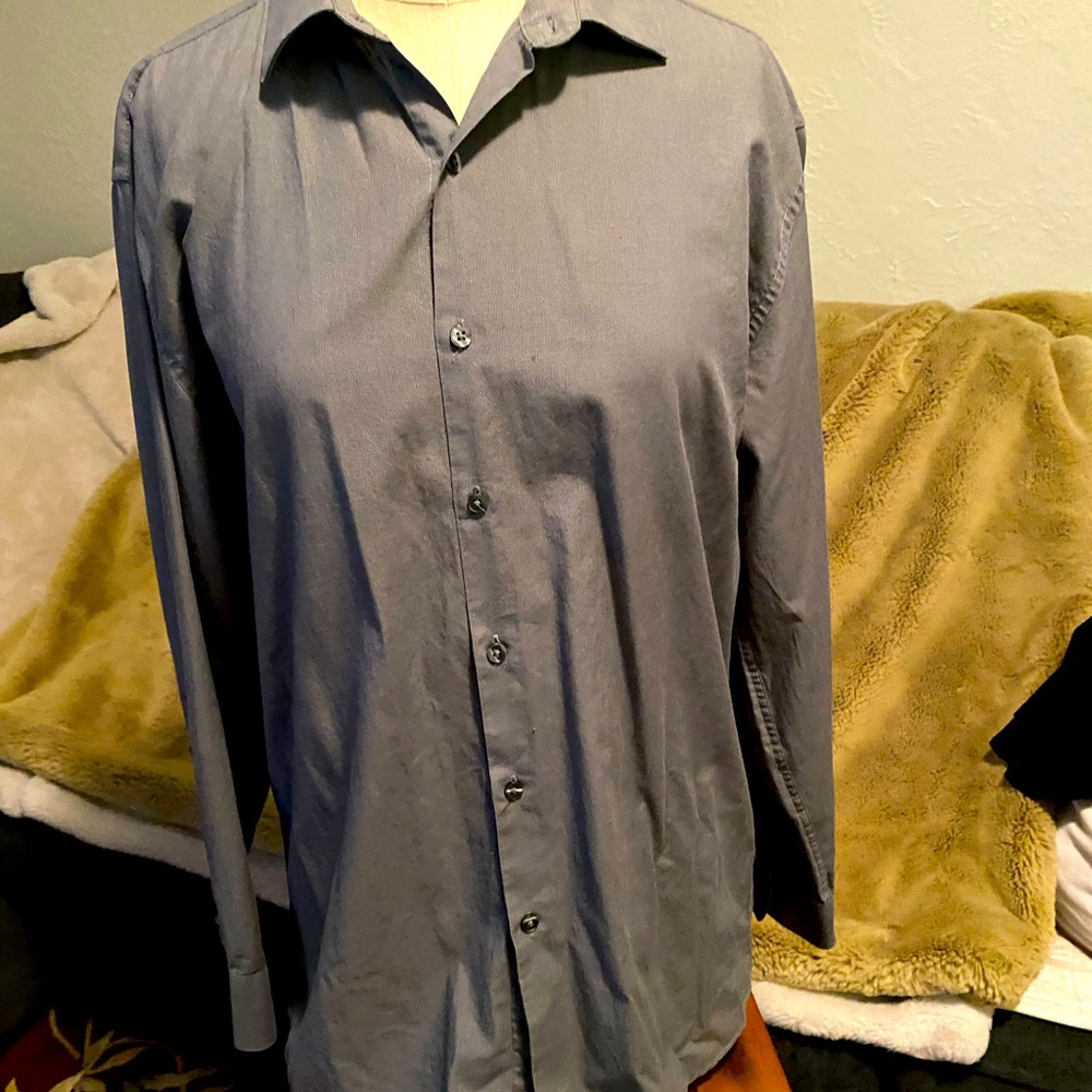 Fitted button up blouse. Falls at hips